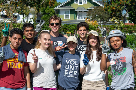 Get Involved - Students volunteering in the garden pose together