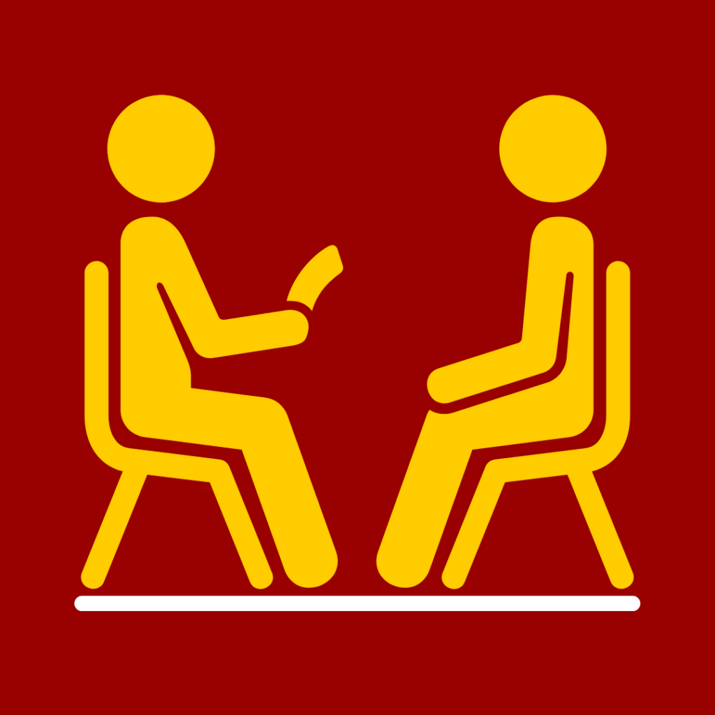 Two people sitting in chairs facing each other that links to Counseling and Mental Health