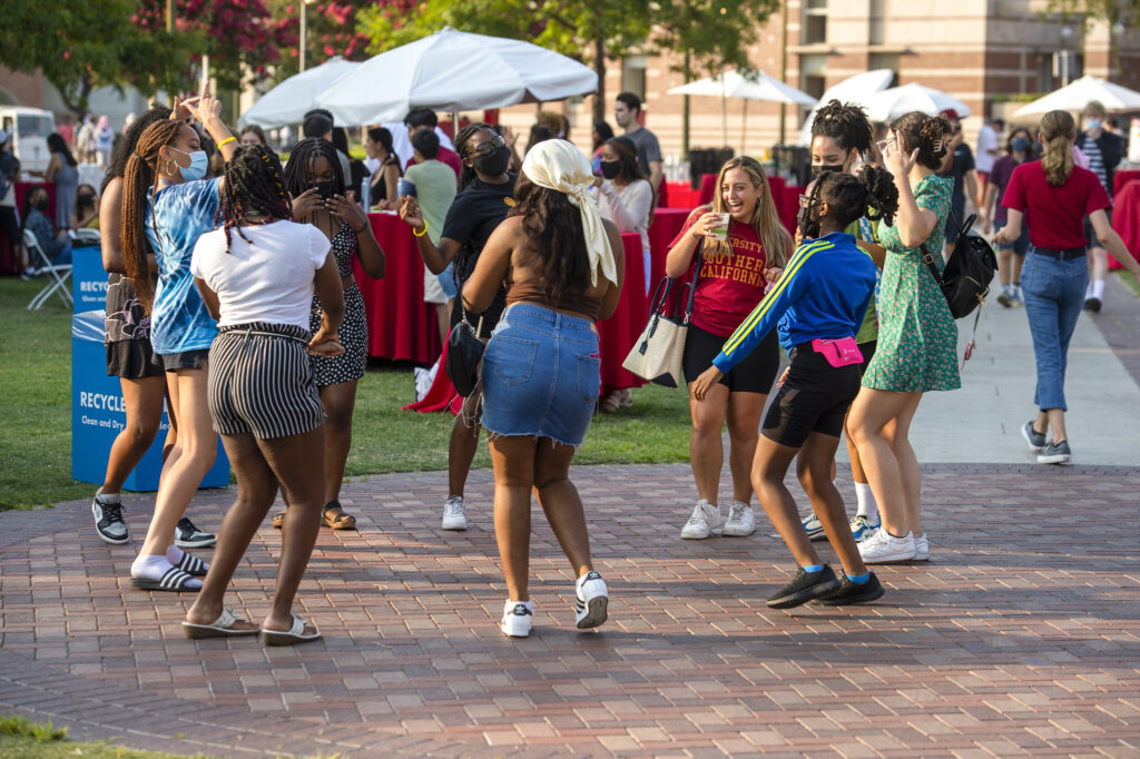 Students dance in a circle at the Welcome dinner